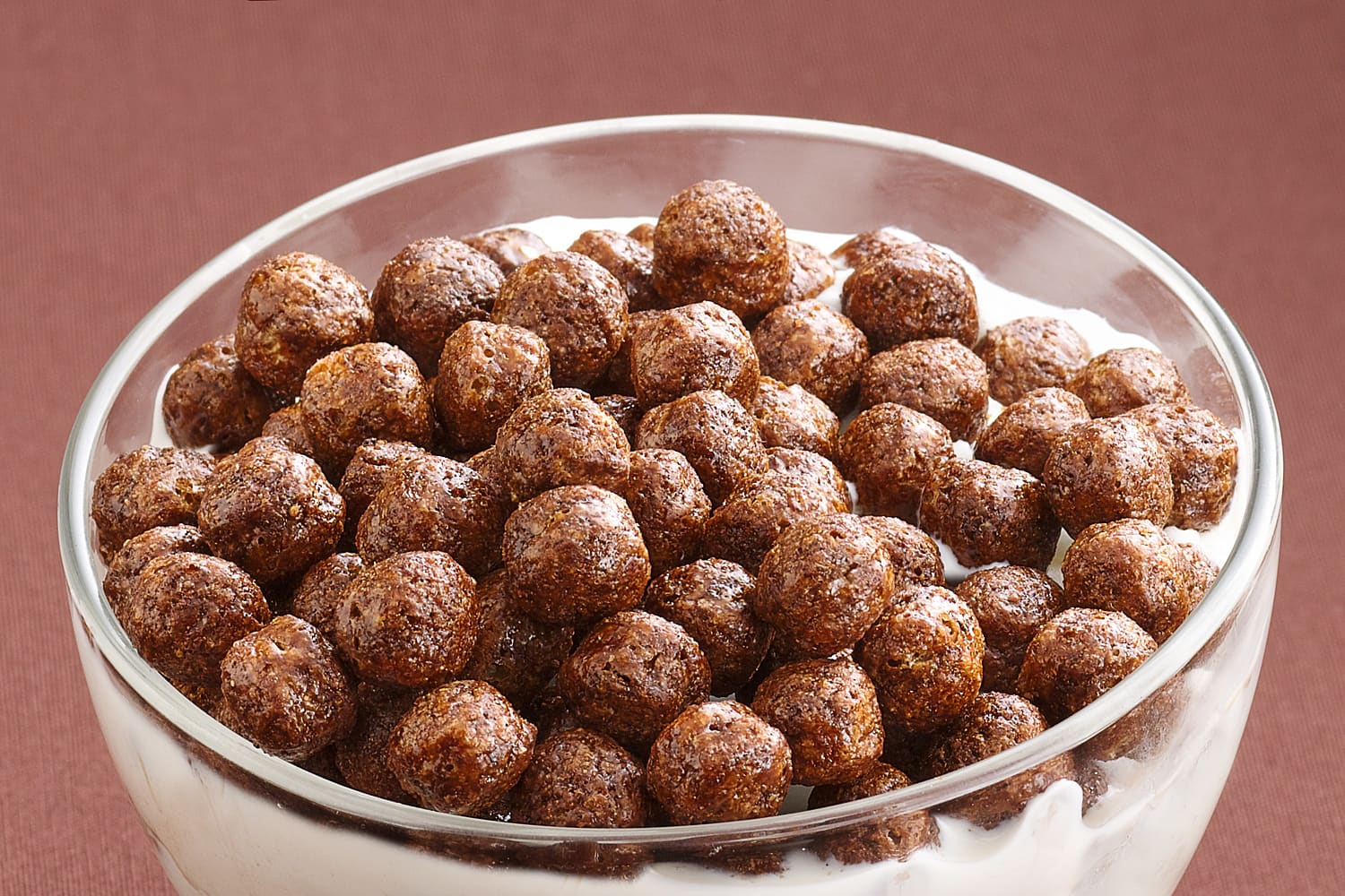 Un recipiente de vidrio lleno de cereal Cocoa Puffs